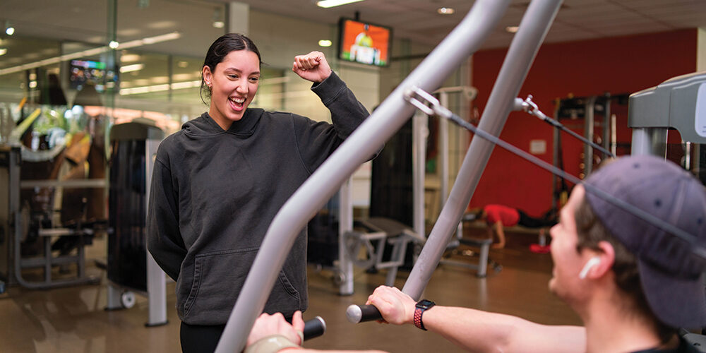 Gym member celebrating wearing a black hoody