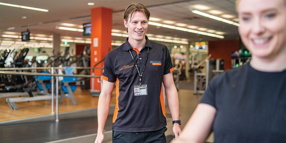 Curtin gym trainer talking to a gym member